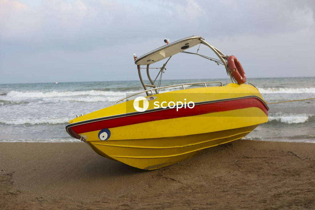 Yellow and white boat on beach