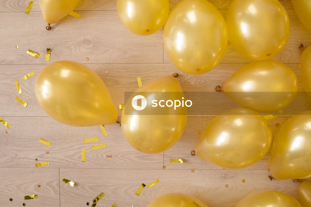 Yellow balloon on brown wooden surface