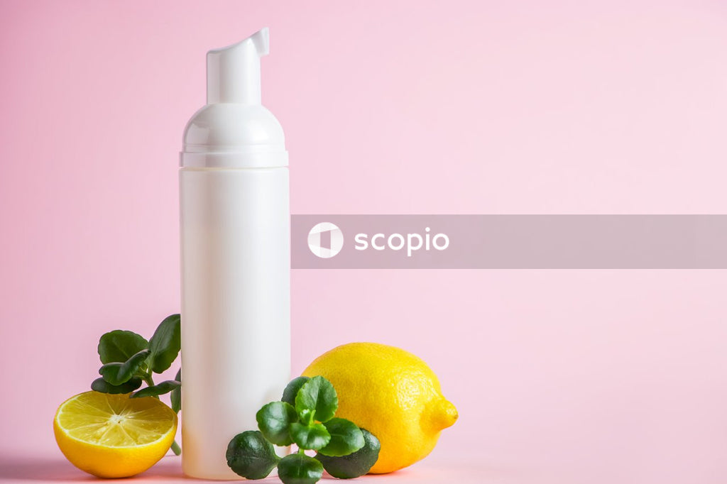 Yellow lemon beside white bottle
