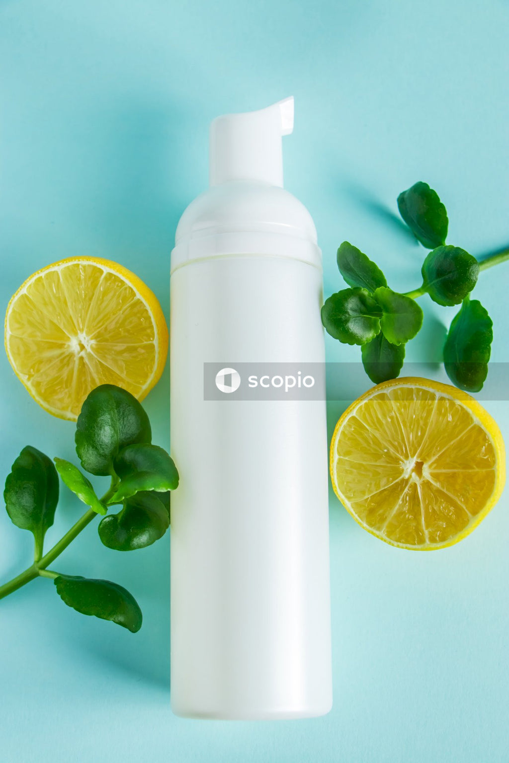 Yellow lemon fruit beside white plastic bottle