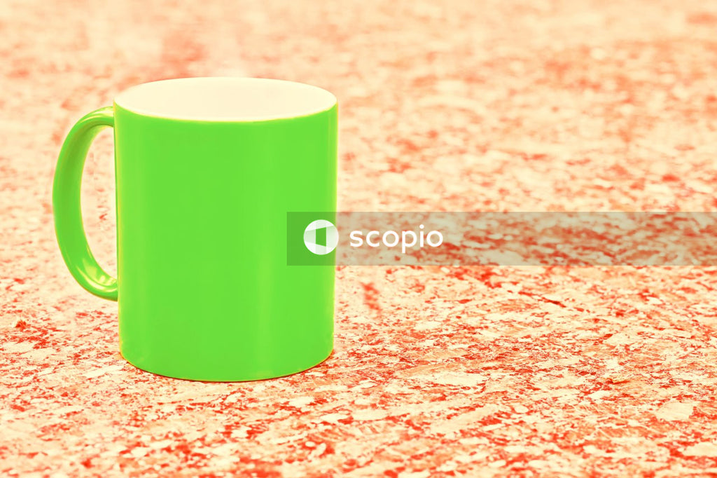 Yellow plastic cup on red textile