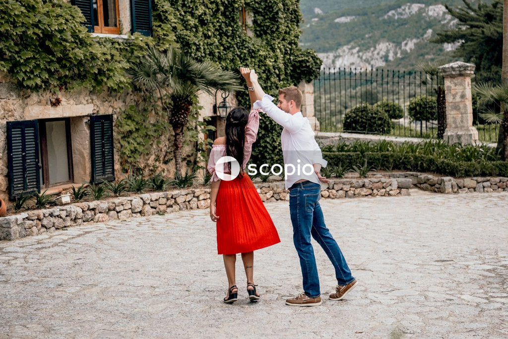 Young couple dancing in a garden during daytime