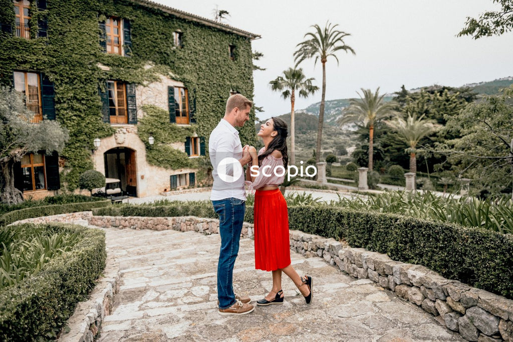 Young couple dancing in a garden during daytime