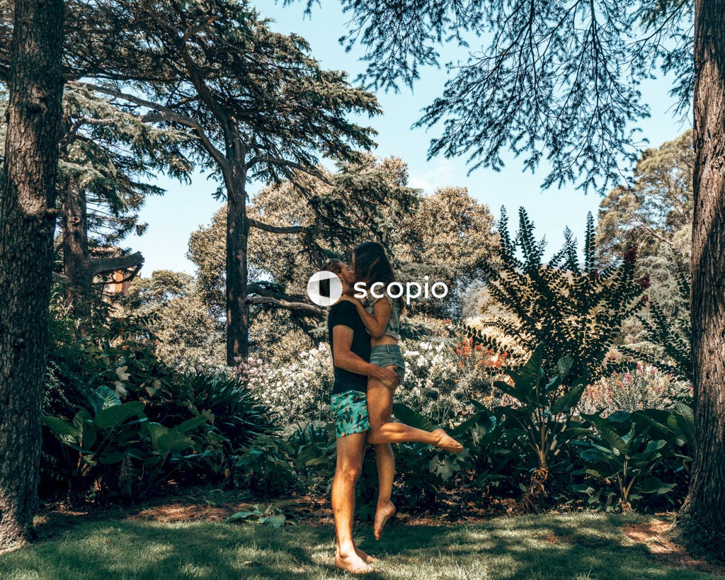 Young couple kissing in nature wearing shorts