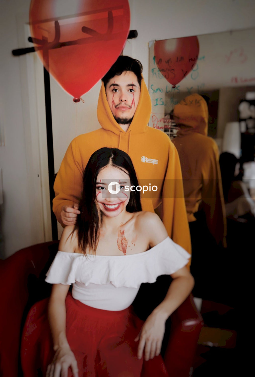 Young man and young woman with joker paint